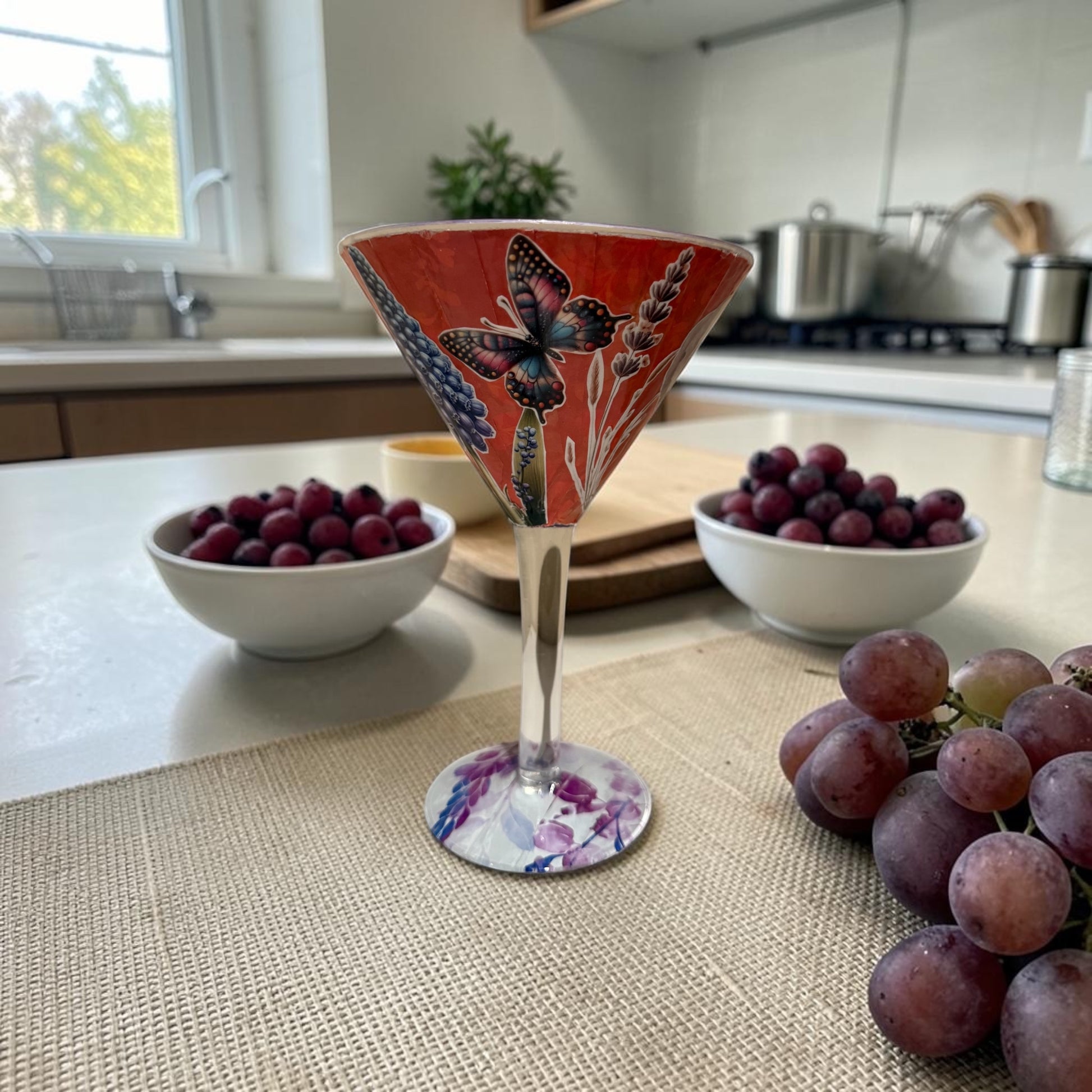 Large cocktail glass on a kitchen counter with grapes.
