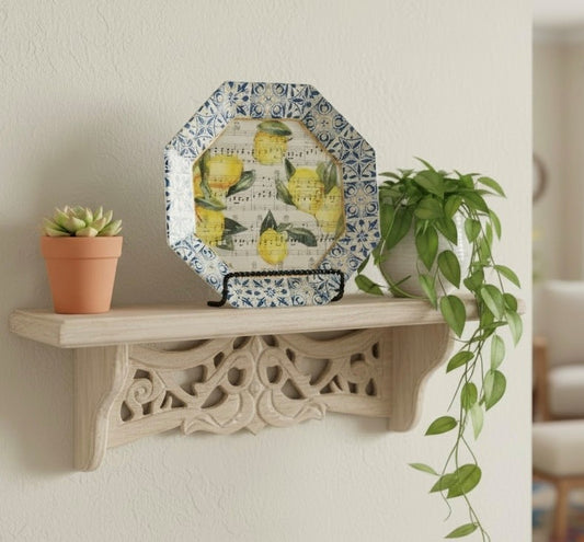 Decorative plate with lemon design on a wooden shelf with plants