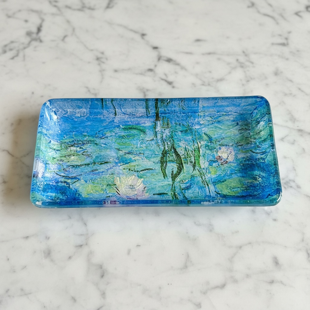 Rectangular glass plate with waterlily design on a marble surface